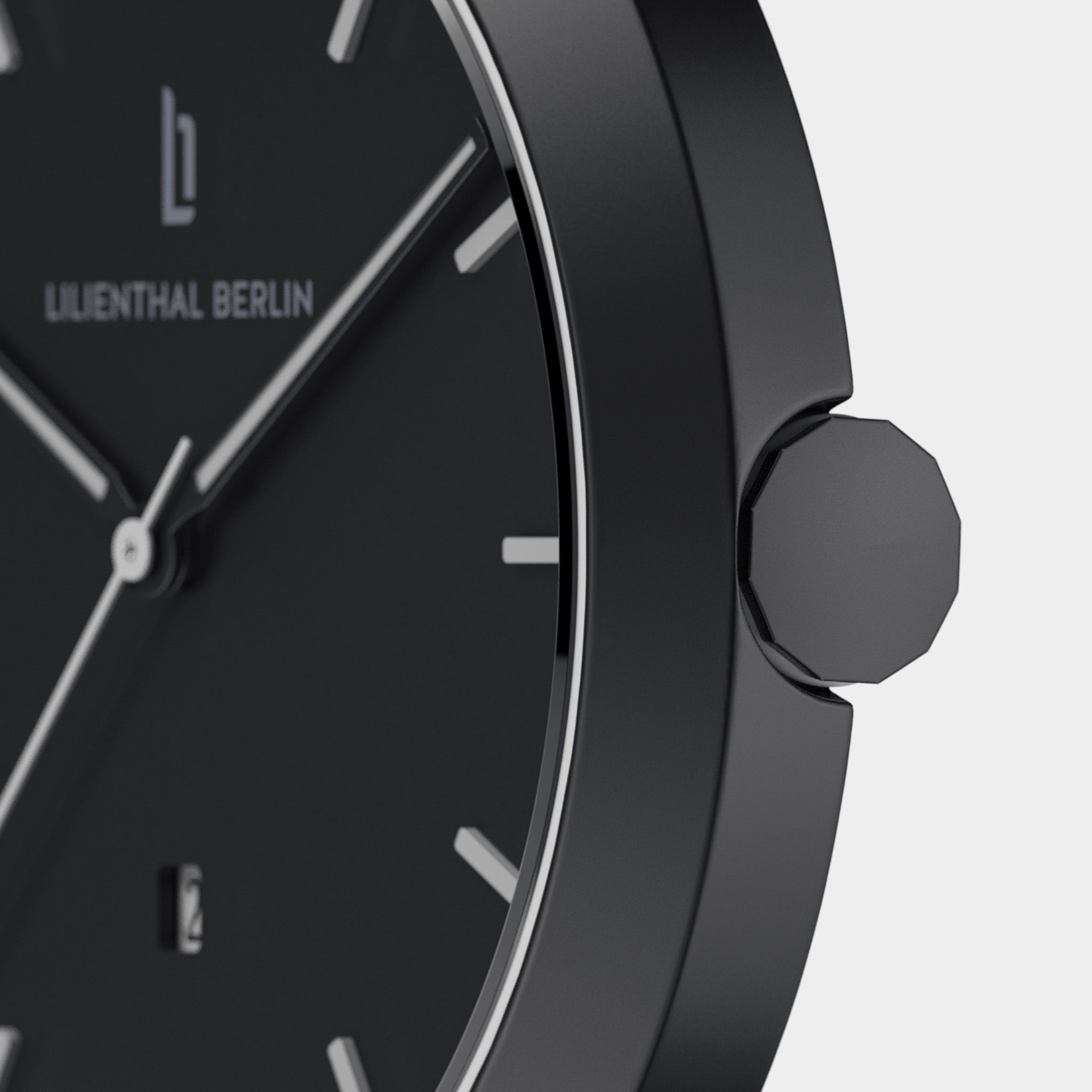 Close-up of minimalist black watch face with silver markers and geometric crown