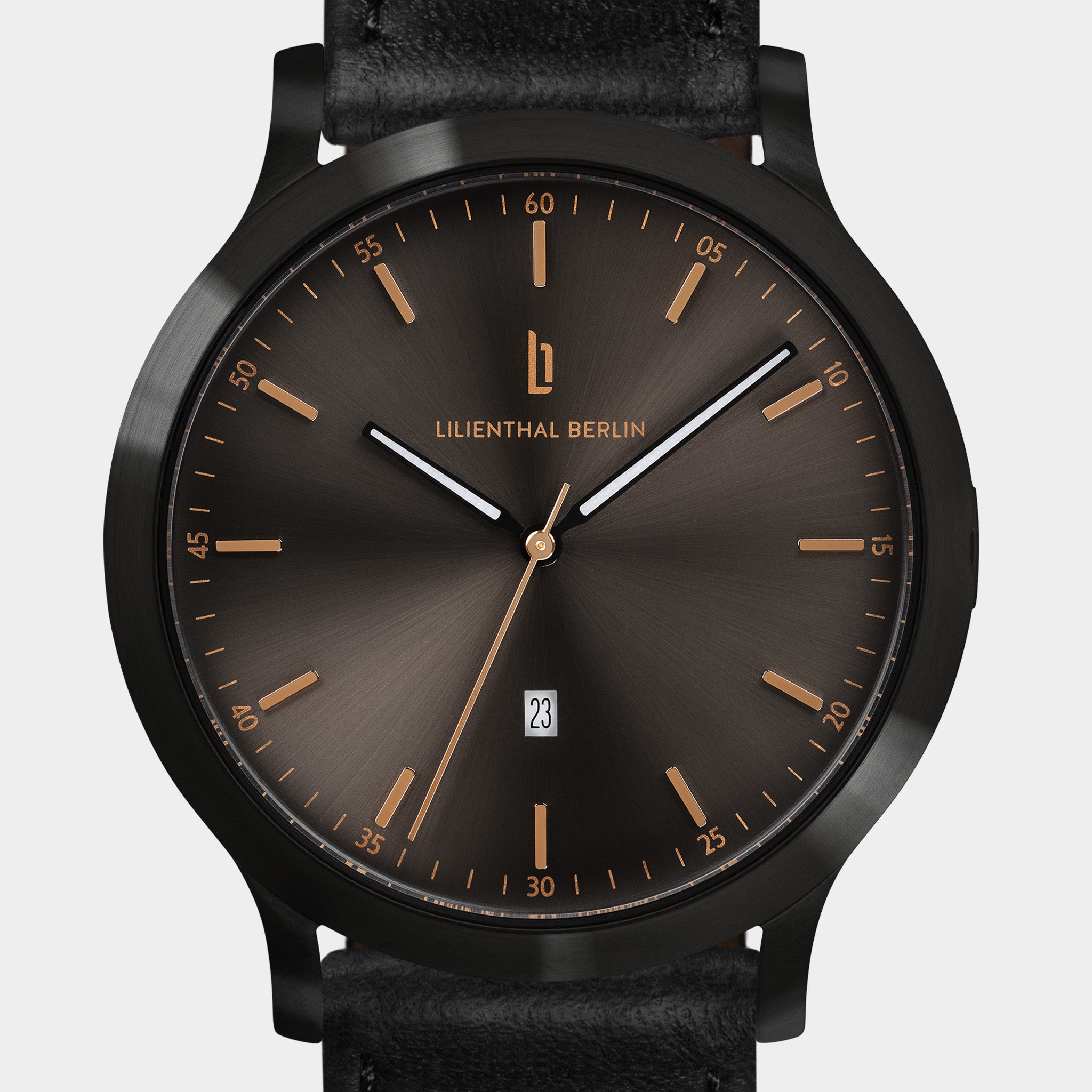 Elegant black watch with sunburst dial, gold hour markers, date display, and black leather strap