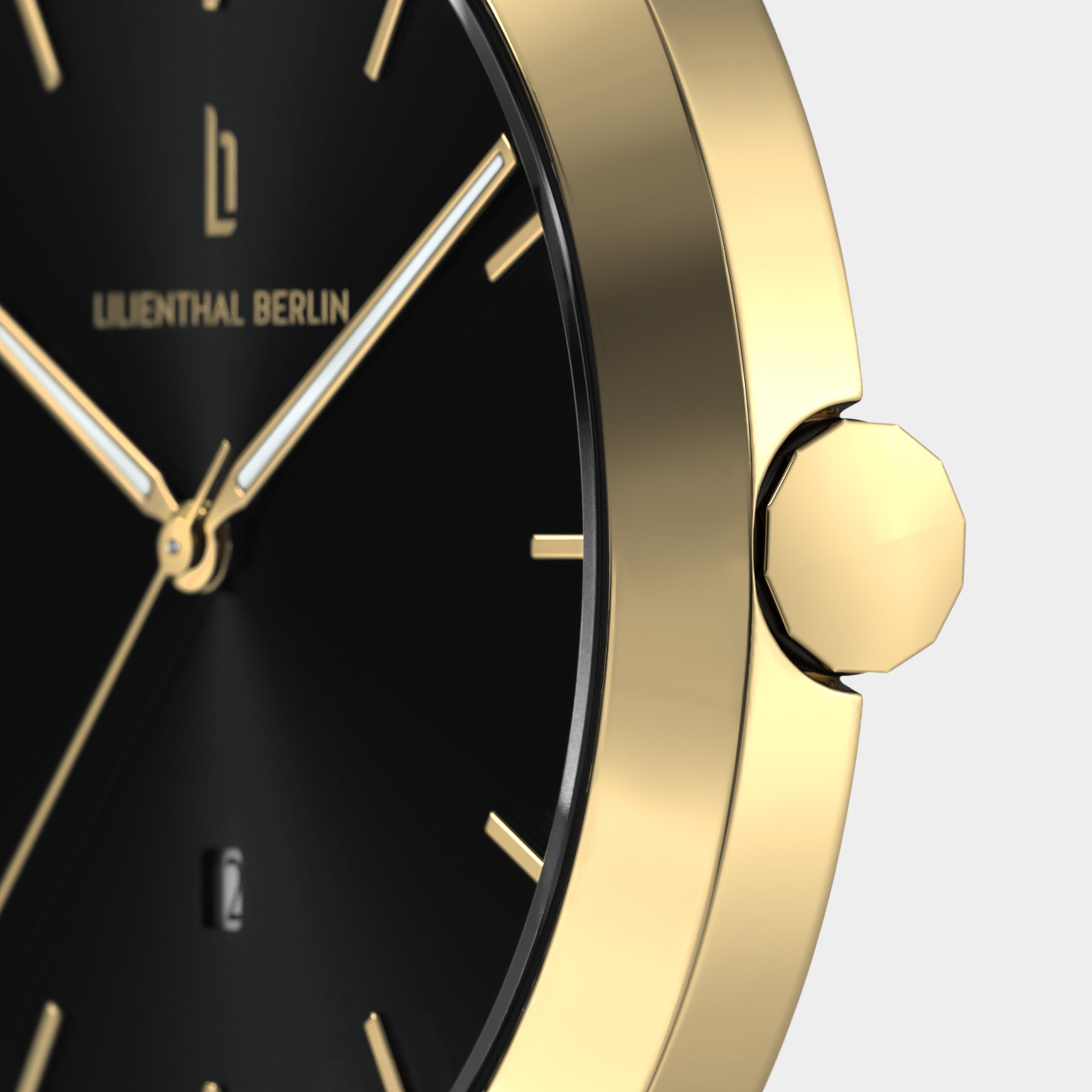 Close-up of a gold minimalist watch with black dial and gold hour markers