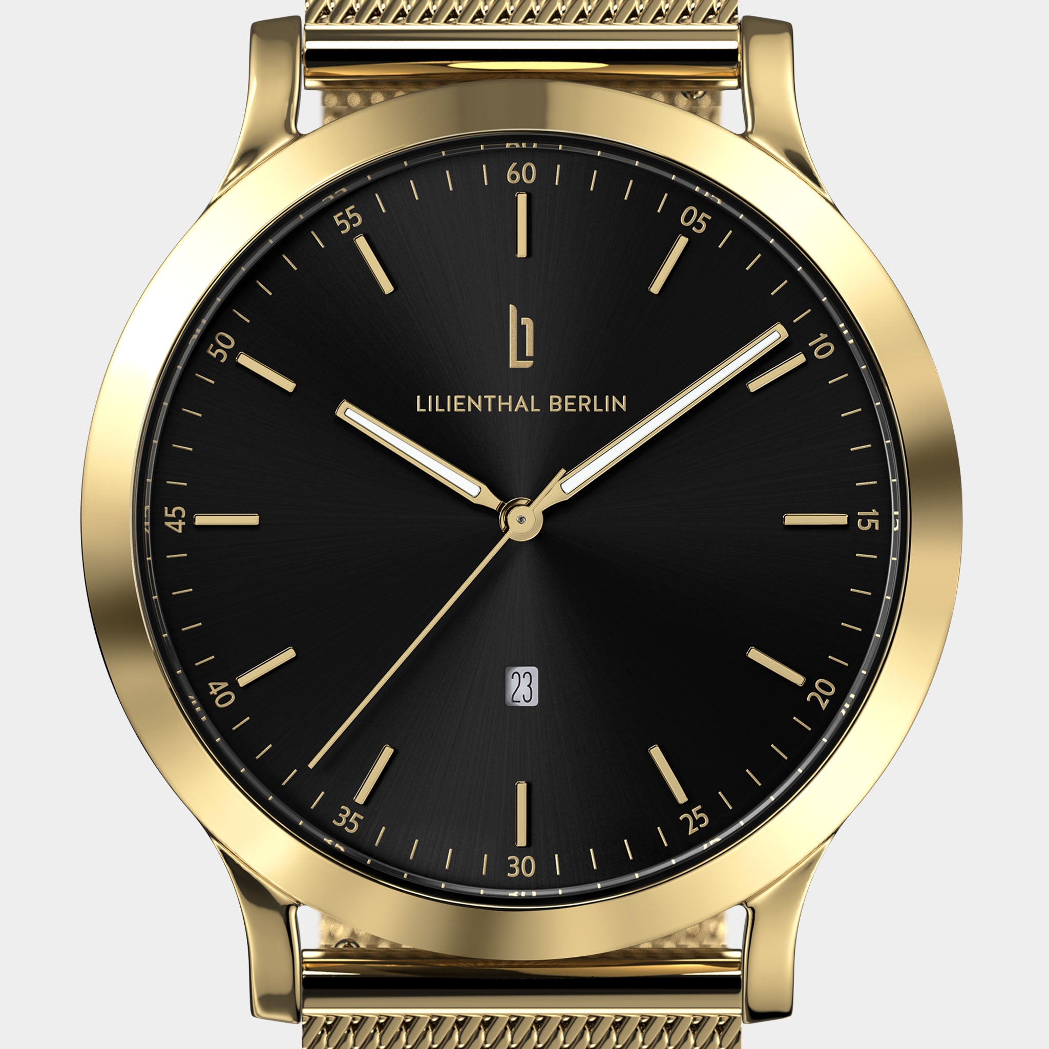 Gold watch with black dial, minimalist markers, mesh strap, and date display at 6 o'clock.