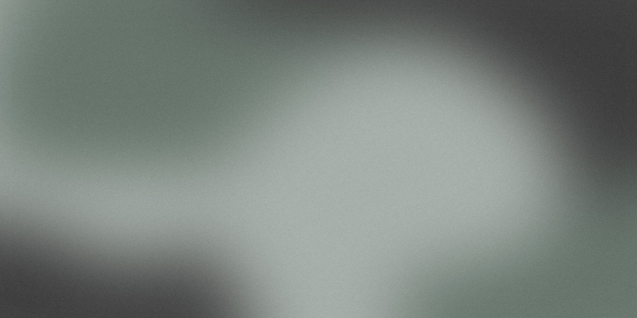 Minimalist grey gradient background with soft, abstract blending