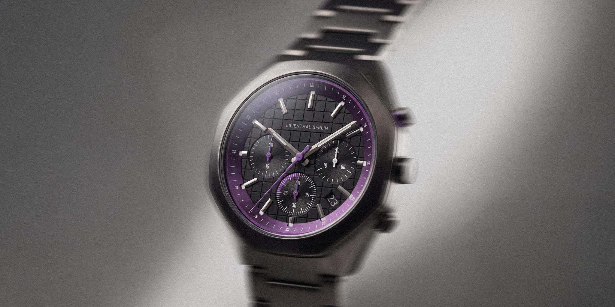 Modern octagonal chronograph watch with purple and gray dial, black metal strap, intricate markers