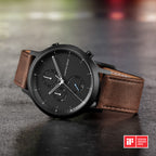 Men’s black chronograph watch with brown leather strap on stone surface, iF Design Award 2020