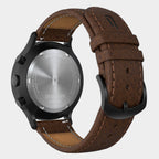 Back of a chronograph watch with brown leather strap and stainless steel case