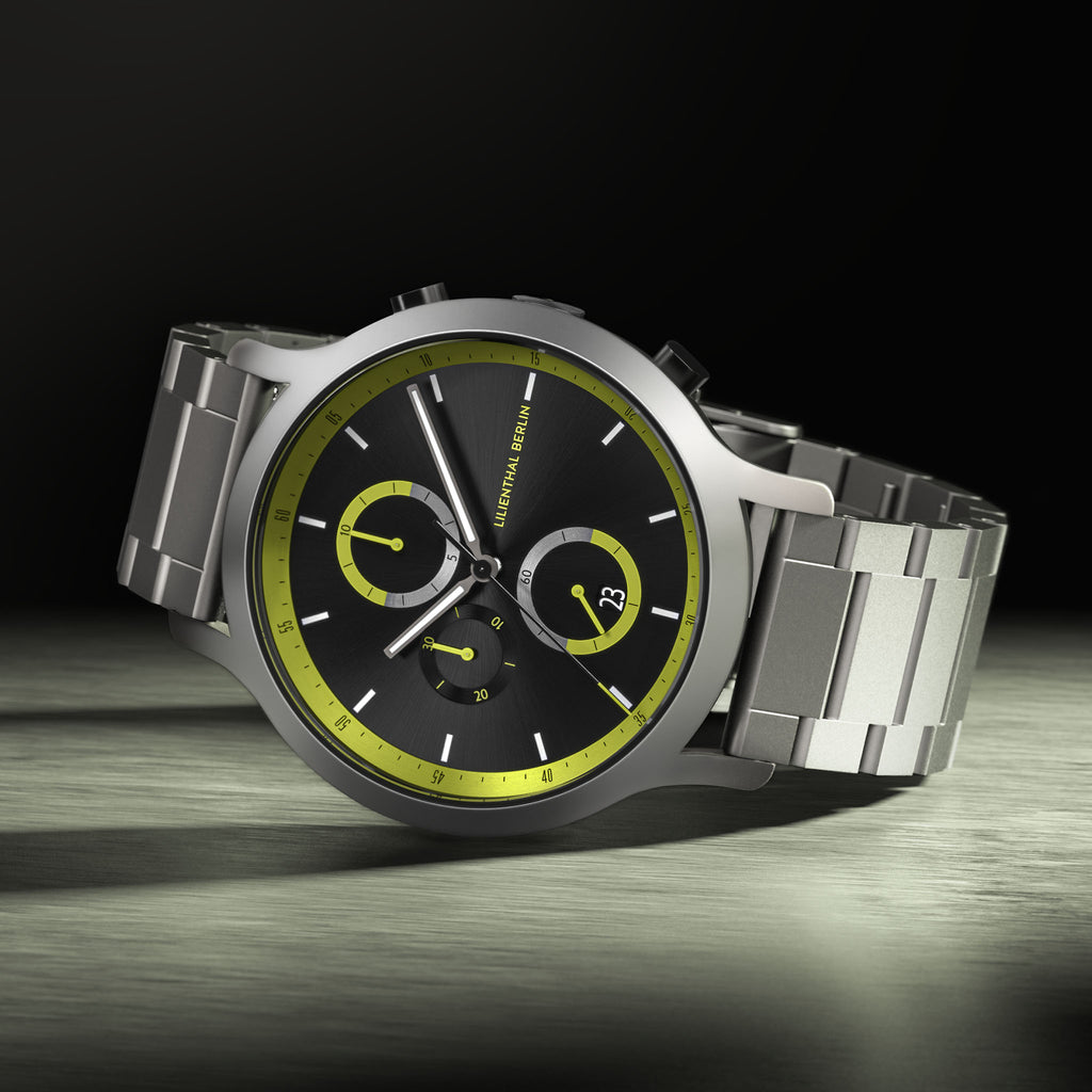 Stainless steel chronograph watch with black dial, yellow accents, and date display