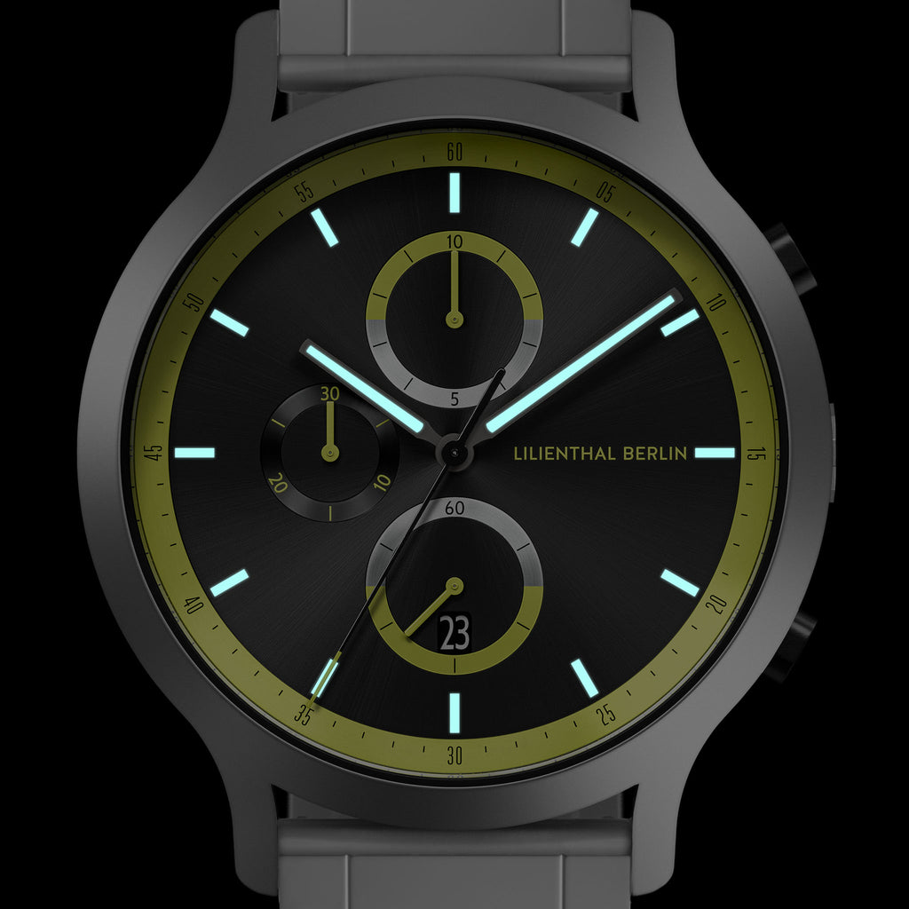 Modern chronograph watch with black dial, green accents, and luminous hour markers