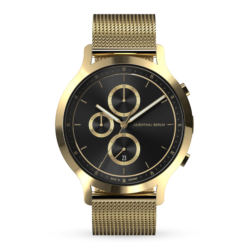Gold mesh band chronograph watch with black and gold dial, minimalist design, date display