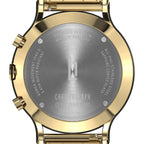 Close-up of gold chronograph watch case back with steel engraving and branded logo