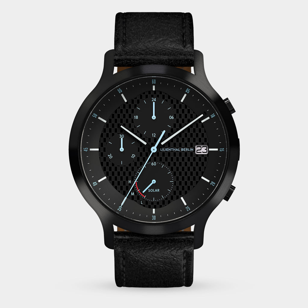 Black chronograph watch with textured dial, date display, solar subdial, and leather strap