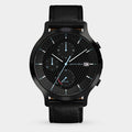 Black chronograph watch with textured dial, date display, solar subdial, and leather strap