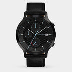 Black chronograph watch with textured dial, date display, solar subdial, and leather strap