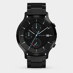Black chronograph watch with solar dial, metal strap, and checkered black face
