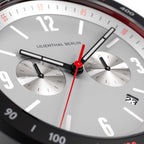 Close-up of modern chronograph watch face with subdials, red second hand, and date display.
