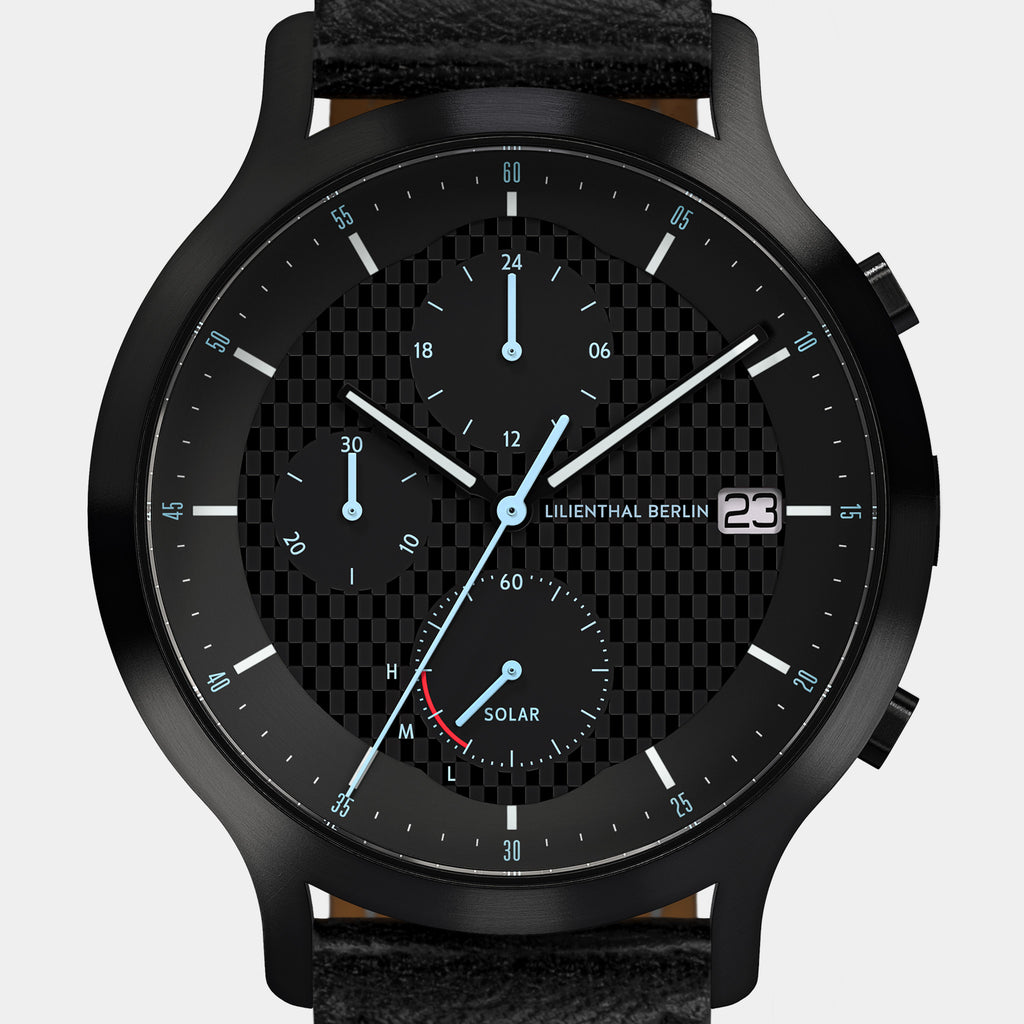 Black chronograph watch with solar subdial, textured checkered dial, and leather strap
