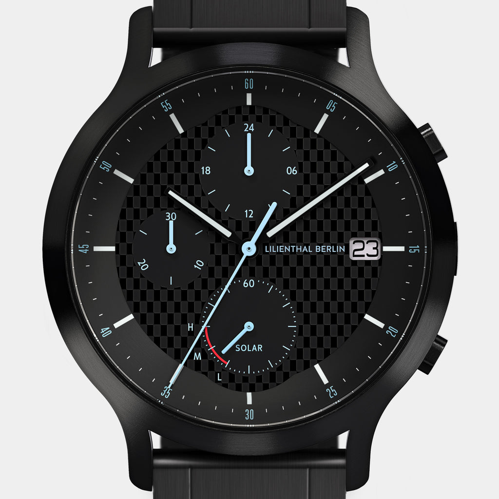 Black solar-powered chronograph watch with subdials, date display, and checkered dial pattern